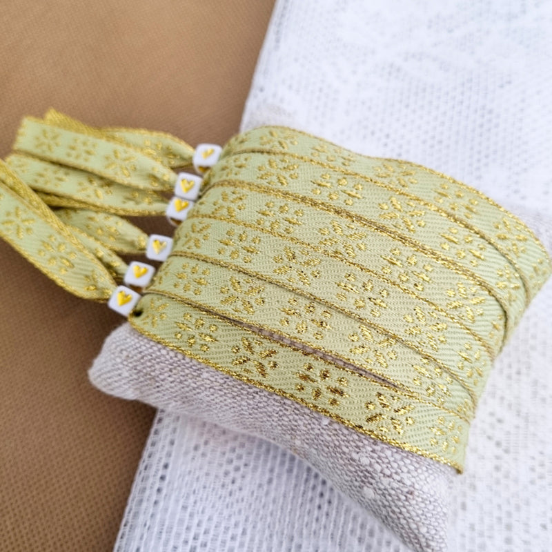 Armband mit Bändern, goldene Blumen